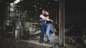 A mother and daughter embracing in a shed burnt by bushfires